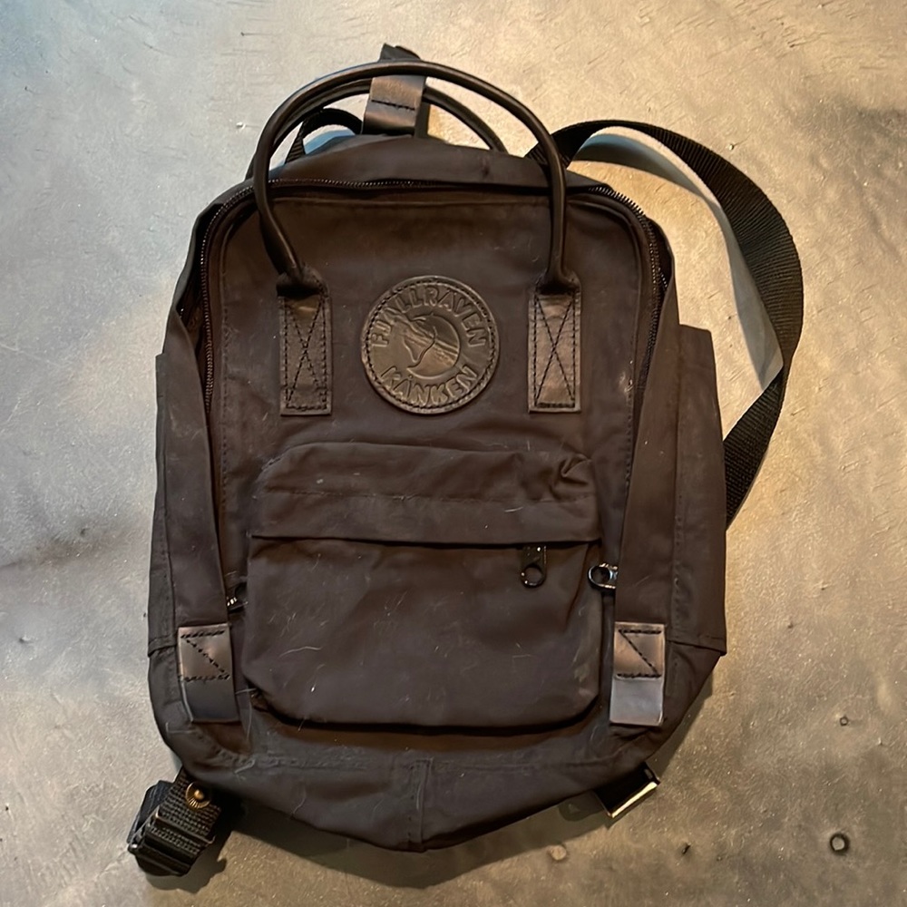 Black Mini Fjallraven Kanken backpack.